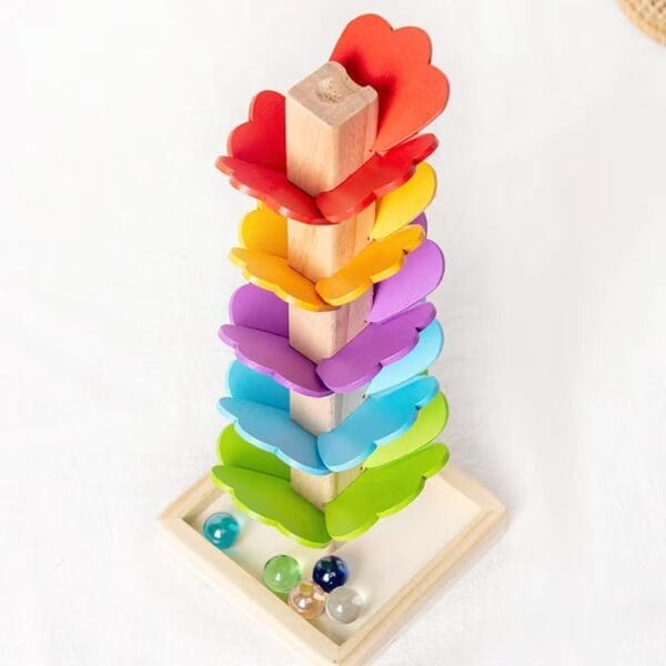 Farbenfrohes Klangbaum-Spielzeug aus Holz mit regenbogenfarbenen Schmetterlingsstücken und Murmeln. Fördert die motorischen Fähigkeiten und die Musikalität von Kindern.
