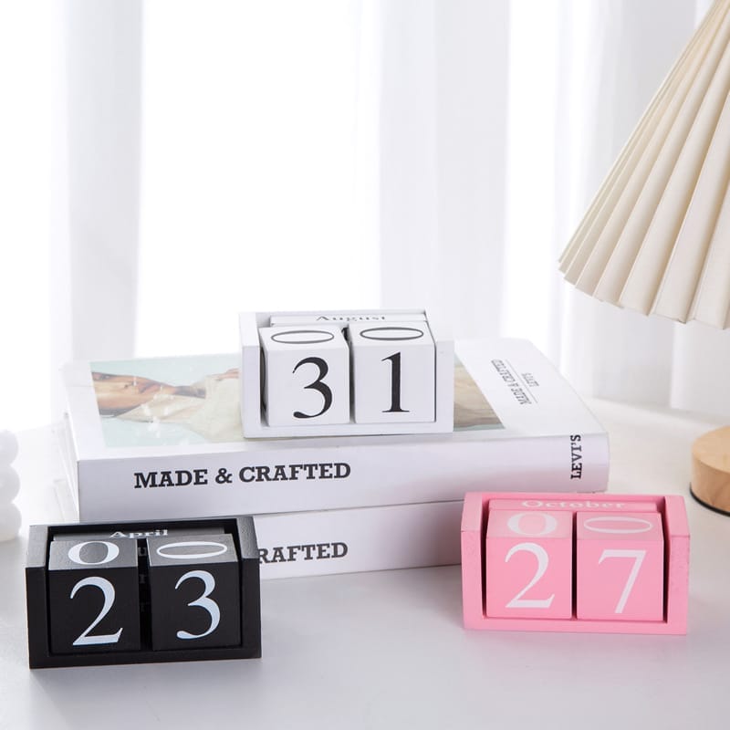 Drei stilvolle Holzblockkalender mit den Daten 23. April, 31. August und 27. Oktober. Perfekt für die Inneneinrichtung.