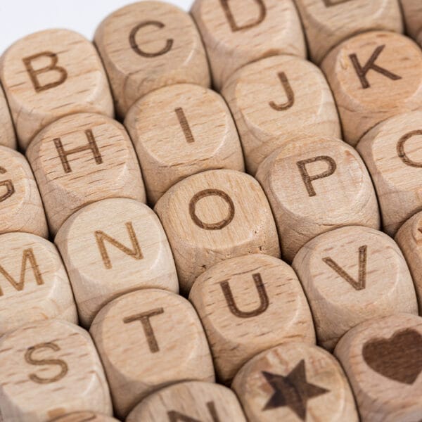 Buchstabenperlen aus Holz für DIY-Projekte von Kindern. Alphabetperlen aus Buchenholz.