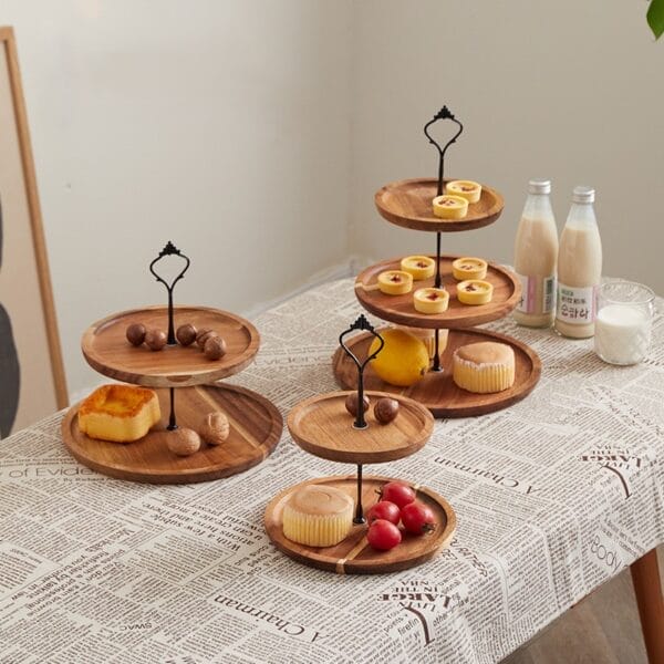 Zweistöckiges Serviertablett aus Holz mit Snacks und Obst. Perfekt für den Heimgebrauch.