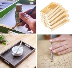 Holztabletts: Unbehandelte Küchen-Nesttabletts mit Griffen werden bemalt und bearbeitet.