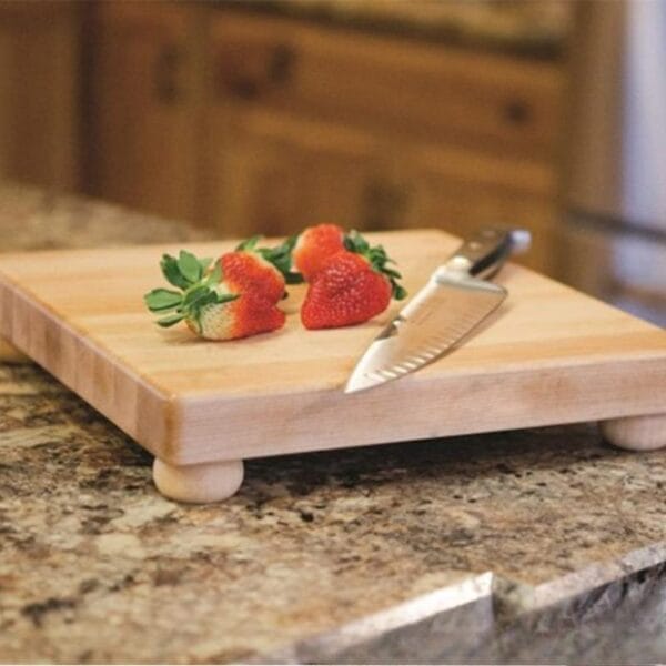 Schneidebrett aus Ahornholz mit Füßen, Erdbeeren und Messer. Perfekt für die Küche.